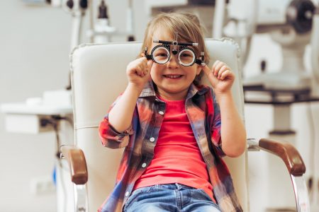 Little,Boy,Looking,At,Camera,And,Smiling,While,Sitting,On