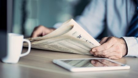 Businessman,Reading,The,Newspaper,On,Table